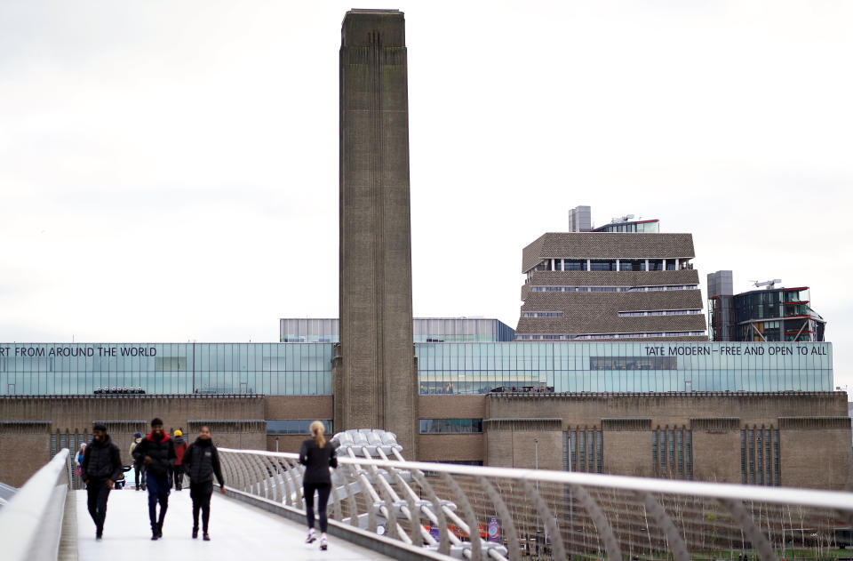 General public walking over the Millennium bridge by the Tate Modern the day after Prime Minister Boris Johnson called on people to stay away from pubs, clubs and theatres, work from home if possible and avoid all non-essential contacts and travel in order to reduce the impact of the coronavirus pandemic.