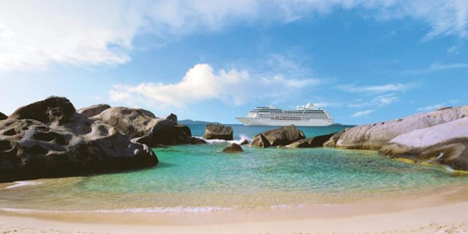 The Insignia sailing by an empty beach.