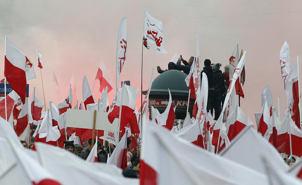 Members of radical right-wing groups light up flares during a march by tens of thousands of people and hosted by President Andrzej Duda that marked 100 years since Poland regained independence in Warsaw, Poland, Sunday, Nov. 11, 2018.(AP Photo/Czarek Sokolowski)