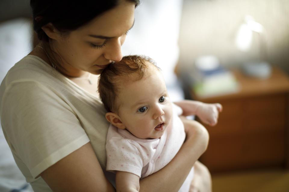 Tired mother and her baby at home