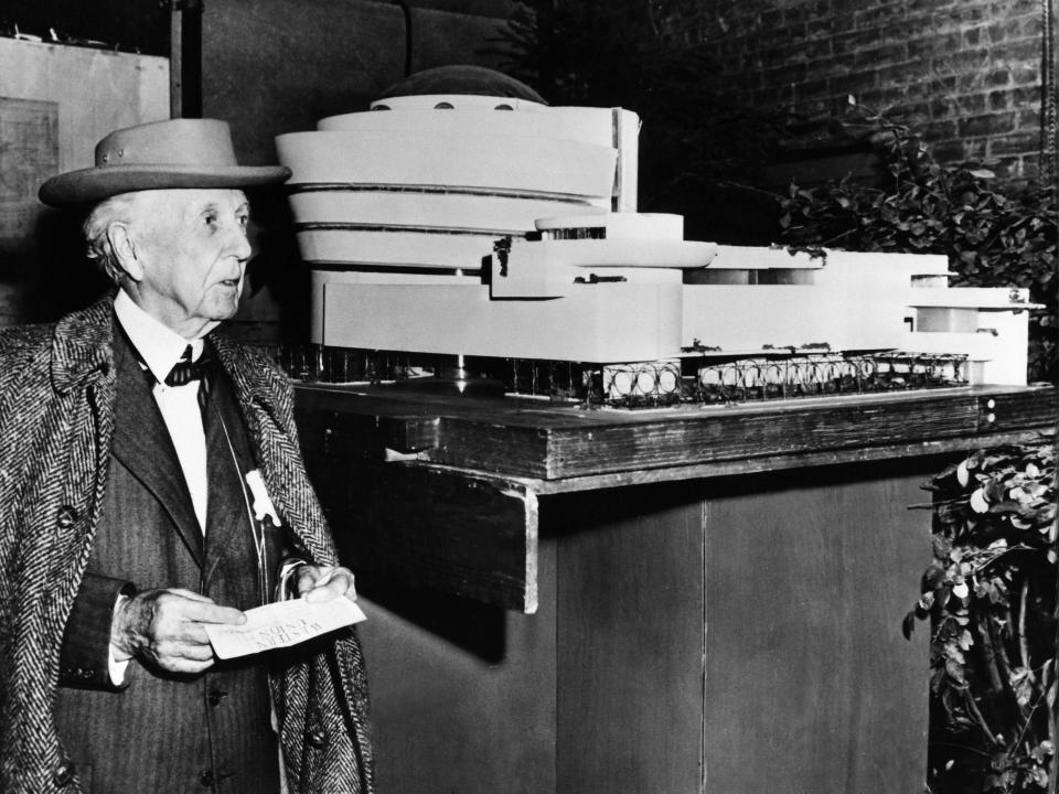 American architect Frank Lloyd Wright next to a model of the Guggenheim Museum.