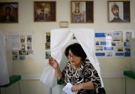 A woman leaves a voting booth during the parliamentary election in Tbilisi, Georgia, October 8, 2016. REUTERS/David Mdzinarishvili