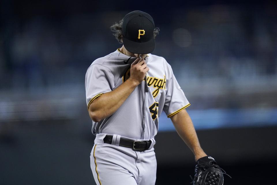 Pittsburgh Pirates starting pitcher Max Kranick walks off the field after being removed in the fourth inning of a baseball game against the Arizona Diamondbacks, Wednesday, July 21, 2021, in Phoenix. (AP Photo/Ross D. Franklin)