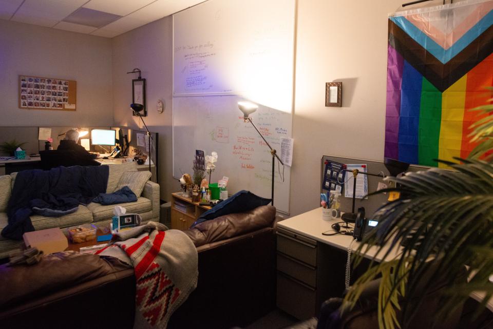 Comfy couches, supportive sayings and inclusive flags decorate the call center area where a volunteer at the Kansas Suicide Prevention Headquarters works from her computer Thursday morning.