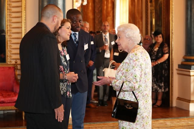 The Queen speaks with Dai Hankey, Dr. Rose Drew, and Pastor Kingsley Avanagh (Jonathan Brady/PA)