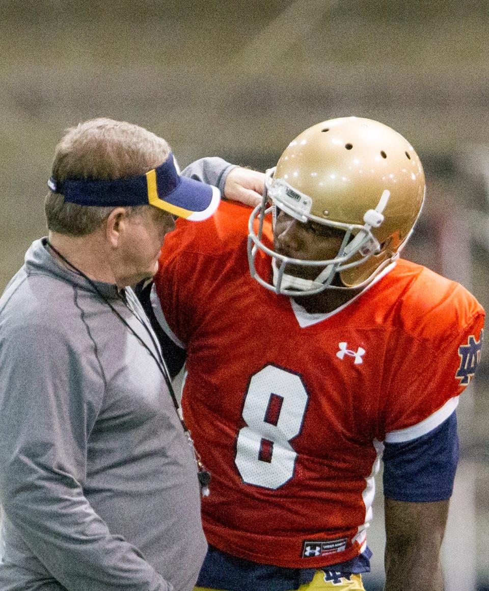 Notre Dame quarterback Malik Zaire (8)talks to Head Coach Brian Kelly during practice Saturday, April 9, 2016 inside the Loftus Sports Center at Notre Dame in South Bend. 