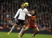 Liverpool's Joe Allen (R) challenges Fulham's Bryan Ruiz during their English Premier League soccer match at Anfield in Liverpool, northern England November 9, 2013.