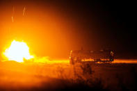 FILE PHOTO: A rocket fired by U.S. soldiers from Dragon Troop of the 3rd Cavalry Regiment explodes next to a destroyed bus at operating base Gamberi in the Laghman province of Afghanistan, December 31, 2014. REUTERS/Lucas Jackson