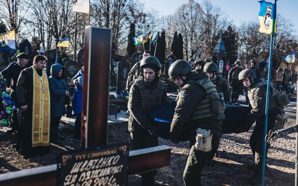 Soldiers carry the coffin of a deceased soldier at a cemetery in Kyiv on Friday  - Diego Herrera Carcedo/Anadolu Agency