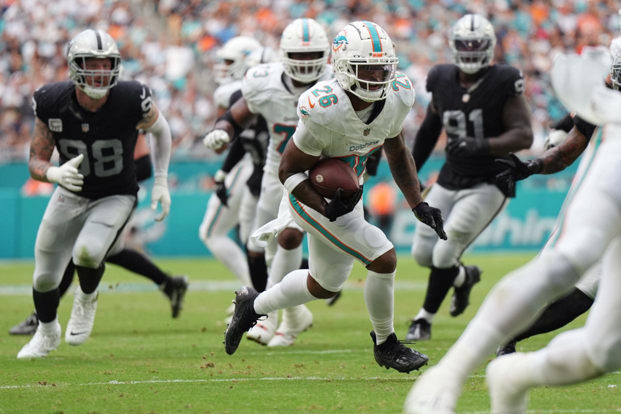 Miami Dolphins running back Salvon Ahmed (26) breaks free for a touchdown during the first half of an NFL game against the Las Vegas Raiders at Hard Rock Stadium in Miami Gardens, Nov. 19, 2023.