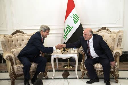 U.S. Secretary of State John Kerry (L) and new Iraqi Prime Minister Haider Abadi shake hands after a meeting in Baghdad September 10, 2014. REUTERS/Brendan Smialowski/Pool