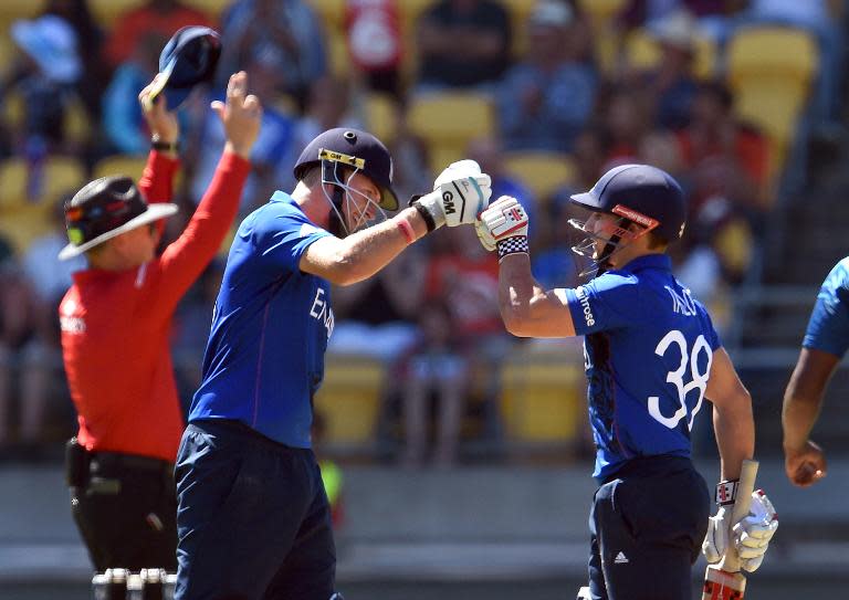 England's batsman Joe Root (L) celebrates another six against Sri Lanka with teammate James Taylor, during their World Cup Pool A match in Wellington, on March 1, 2015