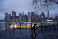 In this Tuesday, March 17 photo, rain clouds hang over the downtown Manhattan skyline in New York. As of Sunday, nearly 2,000 people with the virus have been hospitalized in the state of New York and 114 have died, officials said. More than 15,000 have tested positive statewide, including 9,000 in New York City. (AP Photo/John Minchillo)