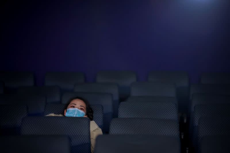 A woman watches the Chinese documentary "Days and Nights in Wuhan" following the outbreak of the coronavirus disease (COVID-19) at a cinema in Beijing