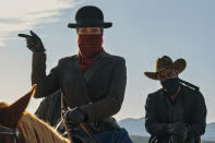 This image released by Netflix shows Regina King, left, and Lakeith Stanfield in a scene from "The Harder They Fall." (David Lee via AP)