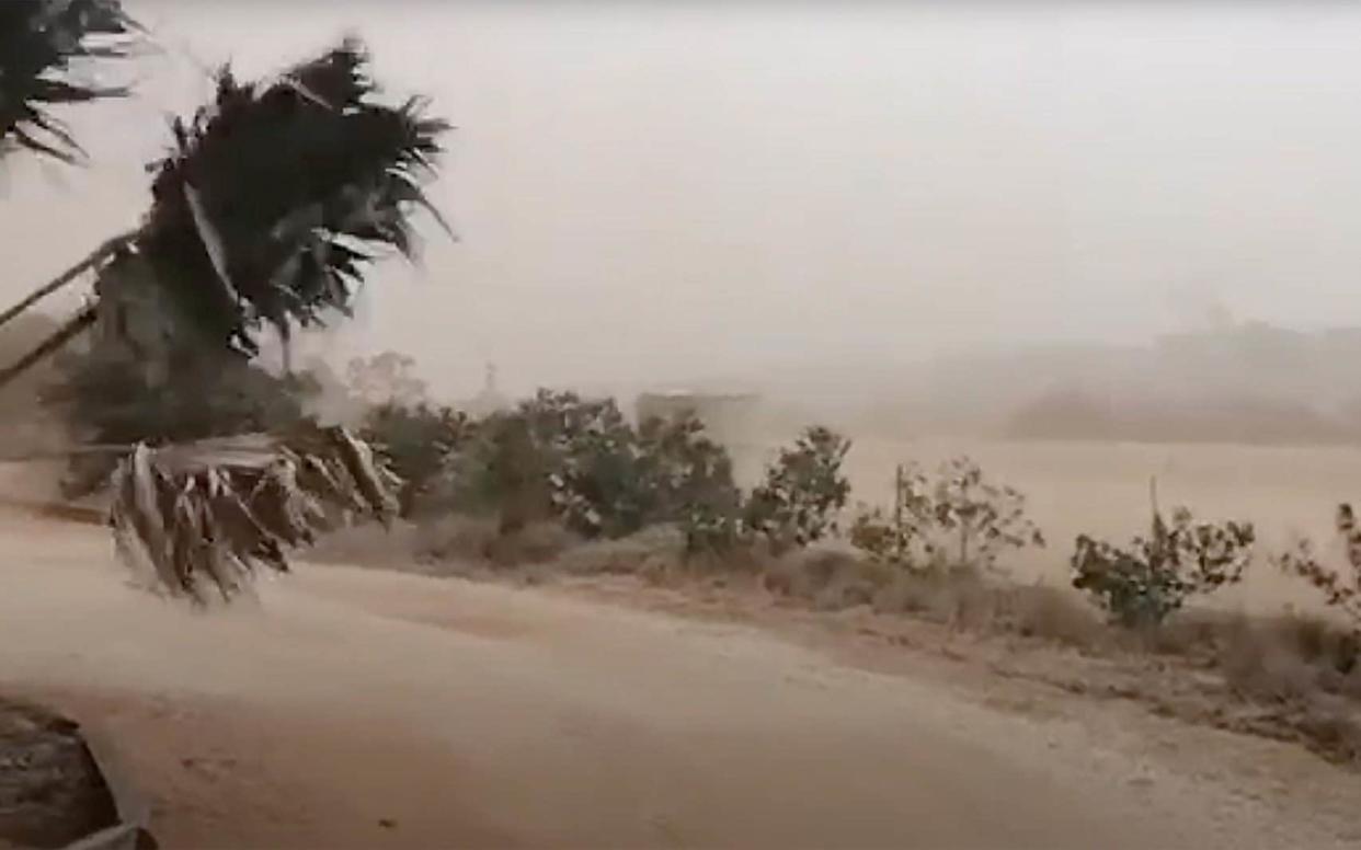 A dust storm blows across Carnarvon, western Australia, with tens of thousands left without power 