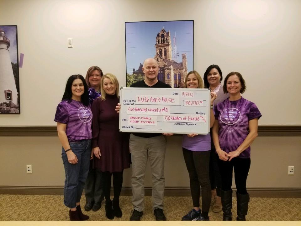 50 Shades of Purple Project committee member Catharine Hadley; Kristi Lewis, TDH Enterprises, case manager; 50 Shades of Purple Project committee member Kami Sayre; Dan Seifert of Community Support Services; Cathy Schellin, Community Support Services director; 50 Shades of Purple Project committee member Angela Zam; and 50 Shades of Purple Project committee chair Corrine McRitchie, the Family and Child Abuse Prevention Center Victim Advocate.