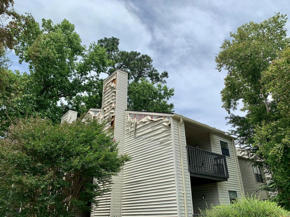 The siding of a building is falling off following a Sunday, June 5, 2022, fire at Mill Creek Apartments in Wilmington.