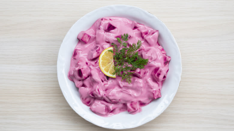 beetroot and yogurt in white bowl on wooden surface