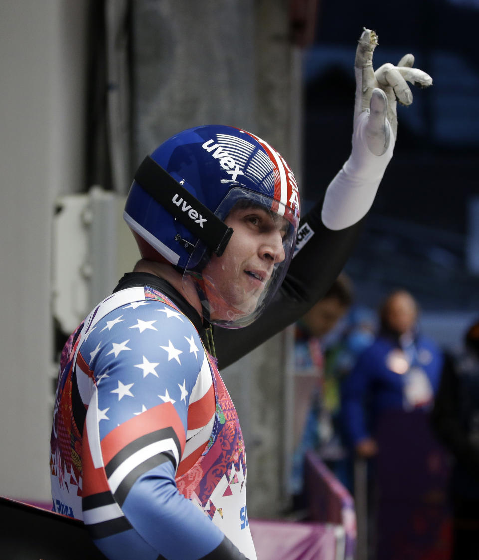 Christopher Mazdzer of the United States waves to fans after finishing his first run during the men's singles luge competition at the 2014 Winter Olympics, Saturday, Feb. 8, 2014, in Krasnaya Polyana, Russia. (AP Photo/Dita Alangkara)