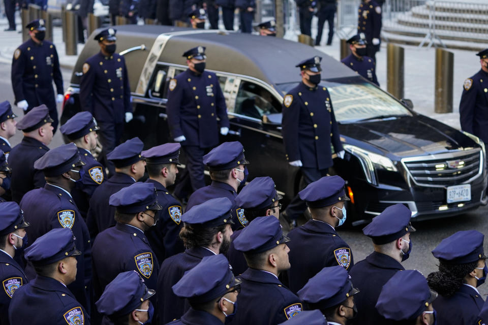 A hearse carrying the casket of New York City Police Officer Wilbert Mora is delivered to St. Patrick's Cathedral for his wake, Tuesday, Feb. 1, 2022, in New York. Mora and Officer Jason Rivera were fatally wounded when a gunman ambushed them in an apartment as they responded to a family dispute. (AP Photo/John Minchillo)