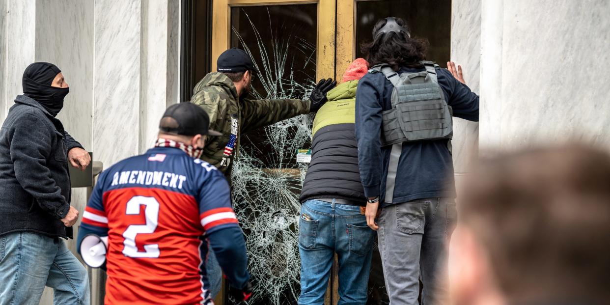 Far right protesters break the door to the Capitol building during a protest against restrictions to prevent the spread of coronavirus disease (COVID 19) in Salem, Oregon, on December 21, 2020. .JPG