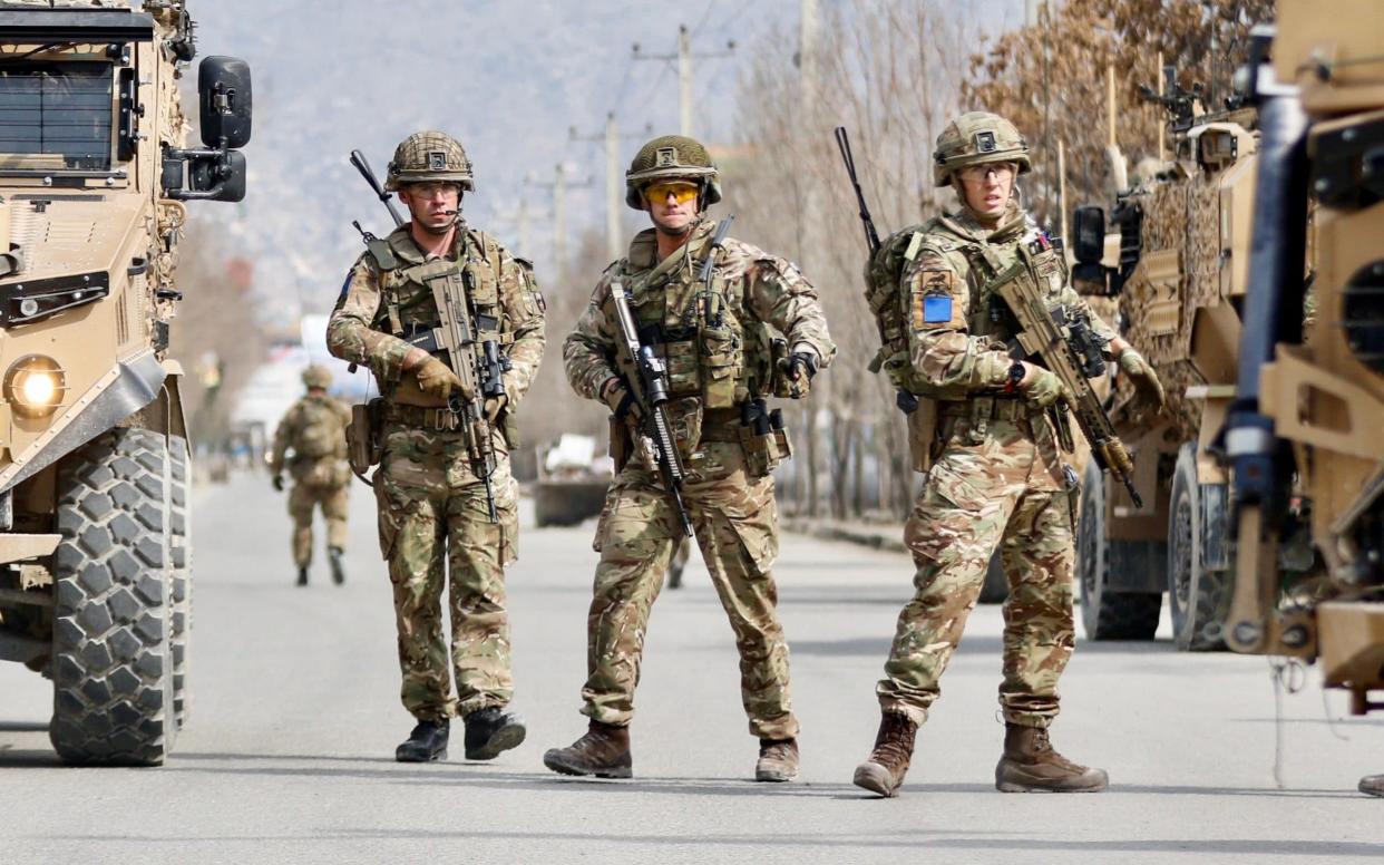 British soldiers stand guard at the site where gunmen attacked a political gathering in Kabul, Afghanistan, 06 March 2020.