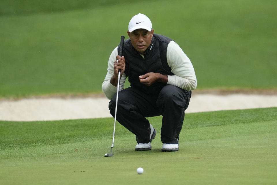 Tiger Woods lines up a putt on the 16th hole during the weather delayed second round of the Masters golf tournament at Augusta National Golf Club on Saturday, April 8, 2023, in Augusta, Ga. (AP Photo/Mark Baker)