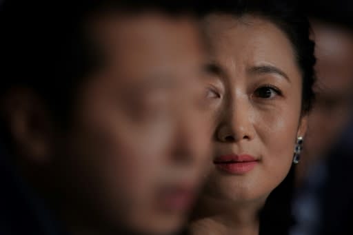 Chinese actress Zhao Tao looks on as her husband director Jia Zhang-Ke (L) talks at Cannes about their latest fil "Ash is Purest White"