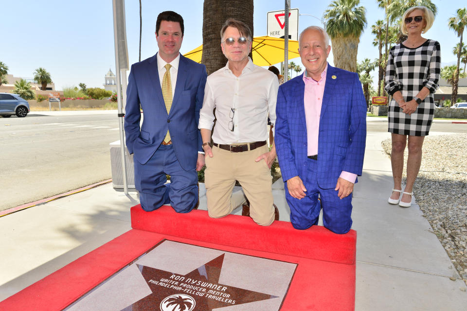 Dax Davis, Ron Nyswaner and Jeffrey Bernstein pose at a star dedication ceremony in Palm Springs