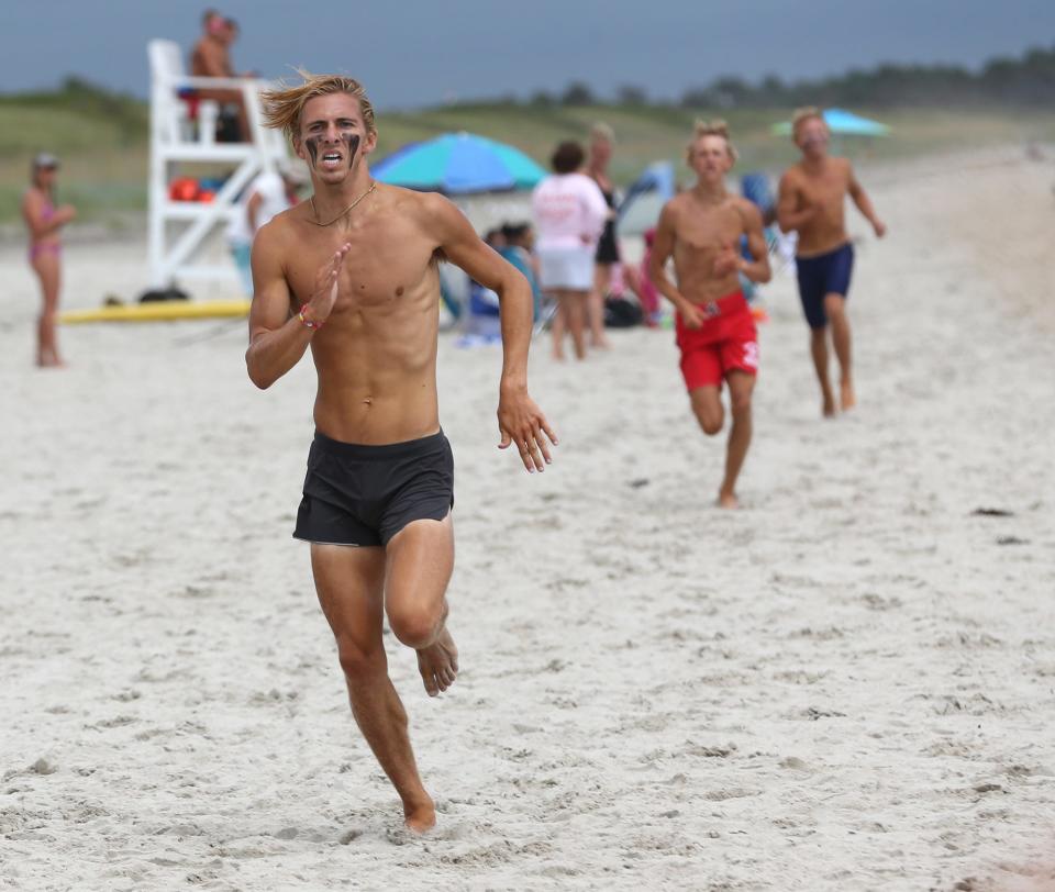 Hampton Beach Lifeguard Spencer Sawyer won first place in the soft sand mile run in the lifeguard competition in Ogunquit Aug. 10, 2022.