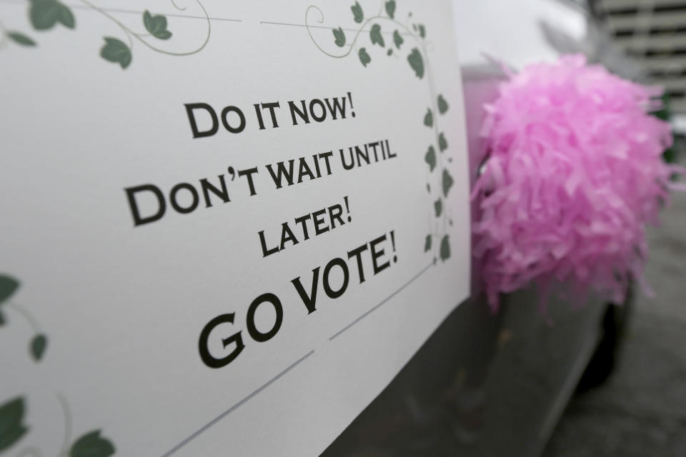 People participate in a "Parade to the Polls" event, organized by Operation Go Vote!, a collaborative of African American civic and social organizations, in New Orleans, Saturday, Oct. 24, 2020. In the best of times, it’s a massive logistical challenge to get millions out to vote. In 2020, the difficulty has been dramatically compounded: by fear of the coronavirus, by complications and confusion over mail-in ballots, by palpable anxiety over the bitter divisions in the country. (AP Photo/Rusty Costanza)