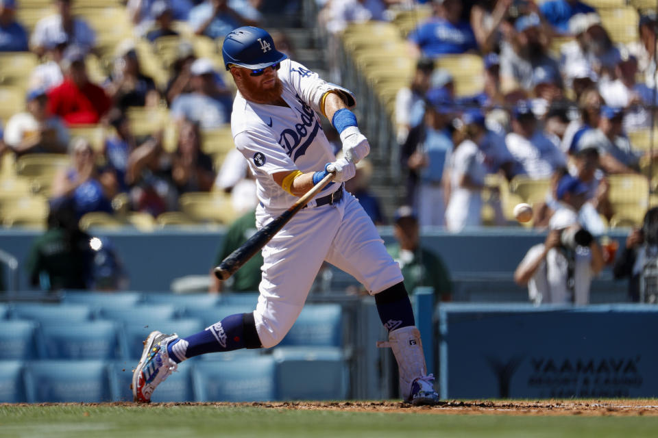 Los Angeles Dodgers' Justin Turner (10) hits a single during the third inning of a baseball game against the Arizona Diamondbacks, Tuesday, Sept 20, 2022, in Los Angeles. (AP Photo/Ringo H.W. Chiu)