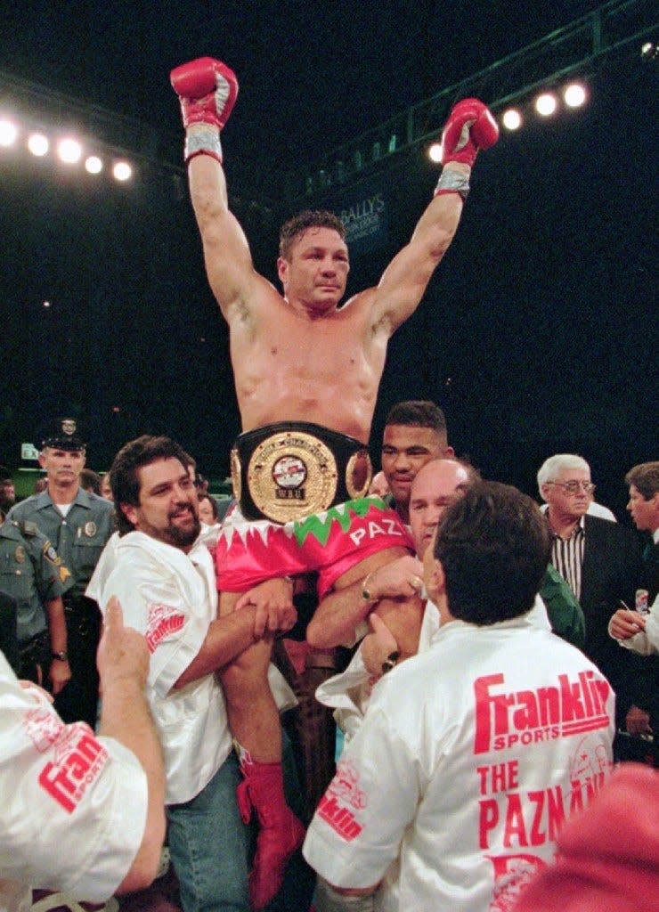 In this Aug. 23, 1996 file photo, boxer Vinny Pazienza, of Providence, R.I., is lifted up after winning a 12 round WBU super middleweight title bout against Dana Rosenblatt in Atlantic City, N.J. Pazienza changed his last name to Paz in 2000. [AP file]