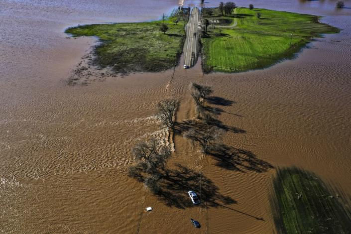 An aerial view of a flooded road.