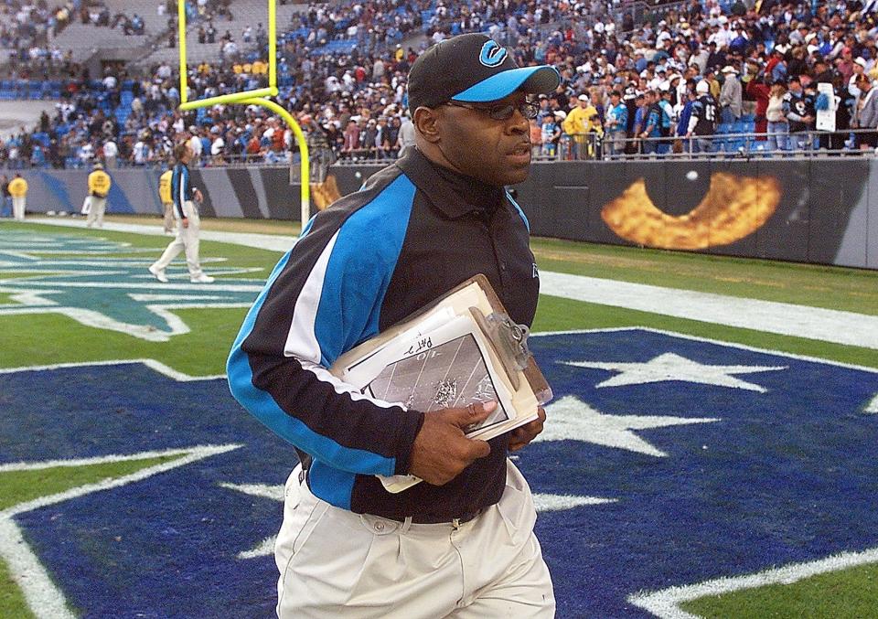 arolina Panthers linebackers coach Sam Mills leaves the field after the Panthers' game against the Washington Redskins in 2003.