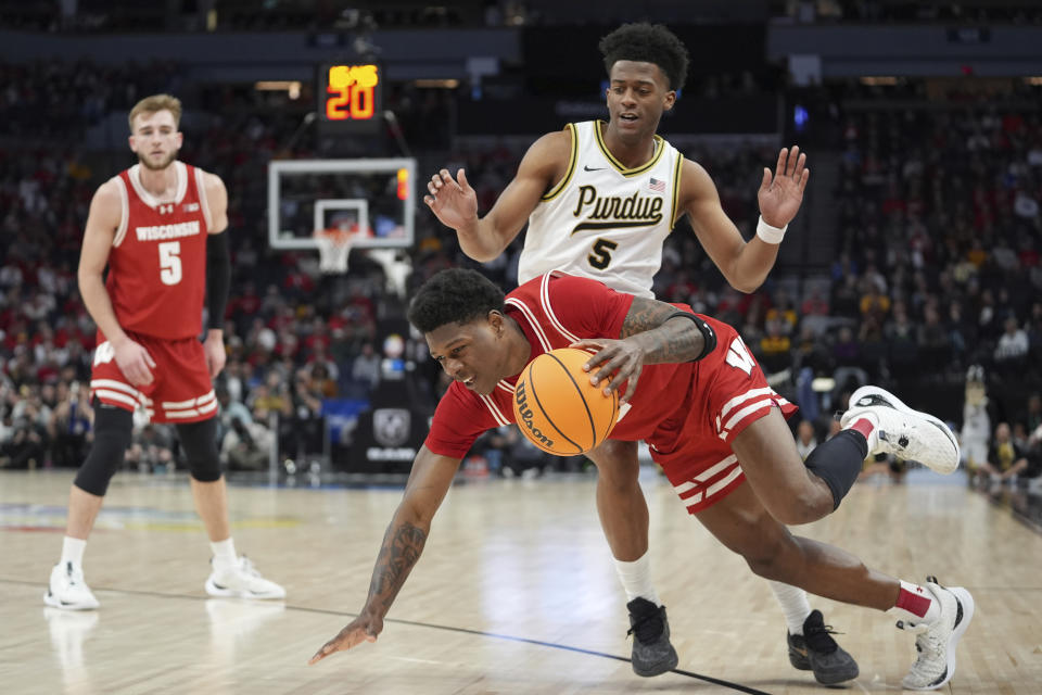 Wisconsin guard AJ Storr, front, works toward the basket as Purdue guard Myles Colvin (5) defends during the second half of an NCAA college basketball game in the semifinal round of the Big Ten Conference tournament, Saturday, March 16, 2024, in Minneapolis. (AP Photo/Abbie Parr)