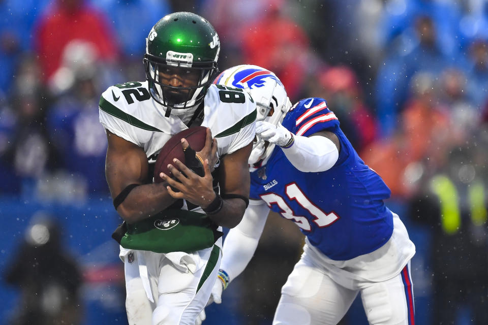 File-New York Jets wide receiver Jamison Crowder (82) catches a pass for a touchdown in front of Buffalo Bills' Dean Marlowe (31) during the second half of an NFL football game Sunday, Dec. 29, 2019, in Orchard Park, N.Y. New York Jets wide receivers Breshad Perriman and Crowder sat out practice Wednesday, Sept. 23, 2020, with injuries, and they could miss the team's game at Indianapolis on Sunday. (AP Photo/Adrian Kraus, File)