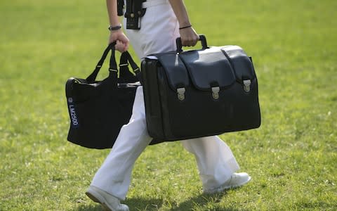 A White House military aide and member o...A White House military aide and member of the US Navy carries a briefcase known as the "football," containing emergency nuclear weapon codes in 2012 - Credit:  SAUL LOEB/AFP