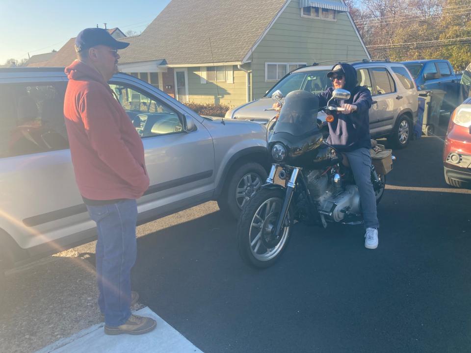 Greg Small, left, chats with son, Matt, who rolled out his Harley for the first time since falling ill in Ireland last December.