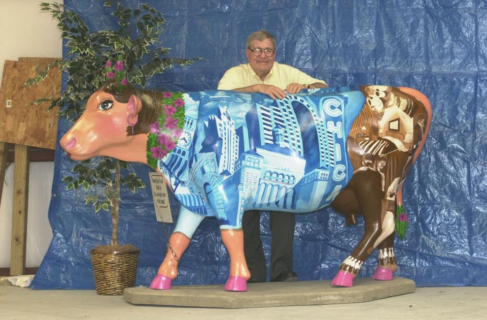 Walter Pancoe stands with the cow named "Accowmodations," which is still on display off Wrightsville Avenue, in 2007.