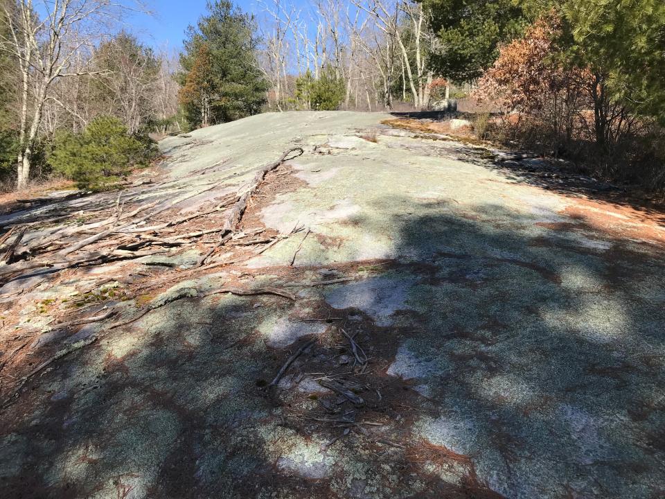 Long, smooth granite ledges slope to the northern tip of 90-acre Blue Pond.