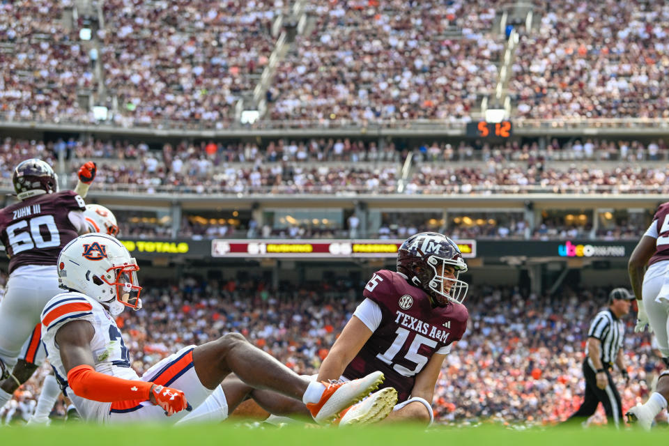 COLLEGE STATION, TX - SEPTEMBER 23: Texas A&M Aggies quarterback Conner Weigman (15) grimaces in pain after taking a hit from Auburn Tigers cornerback Jaylin Simpson (36) just before halftime during the football game between the Auburn Tigers and Texas A&M Aggies at Kyle Field on September 23, 2023, in College Station, Texas. (Photo by Ken Murray/Icon Sportswire via Getty Images)