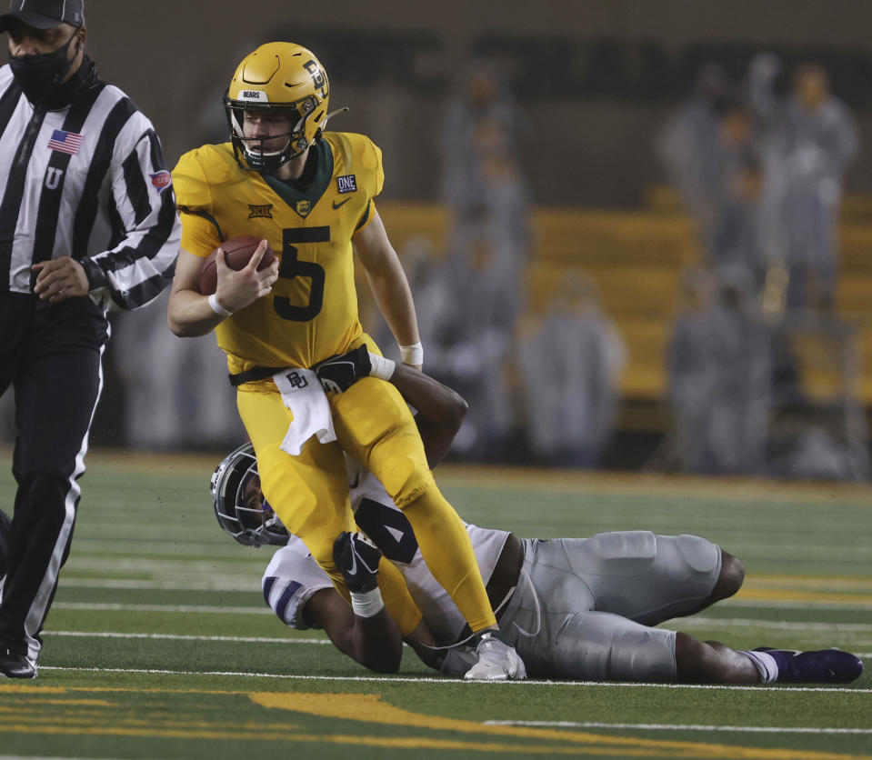 Baylor quarterback Charlie Brewer is pulled down by Kansas State defensive back Wayne Jones during the first half of an NCAA college football game Saturday, Nov. 28, 2020 in Waco, Texas. (Rod Aydelotte/Waco Tribune Herald via AP)