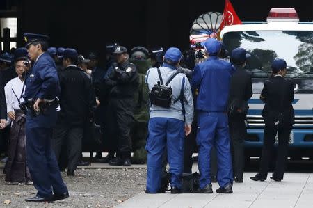 Police and officials stand near the site of a blast at the Yasukuni shrine in Tokyo, Japan, November 23, 2015. REUTERS/Toru Hanai