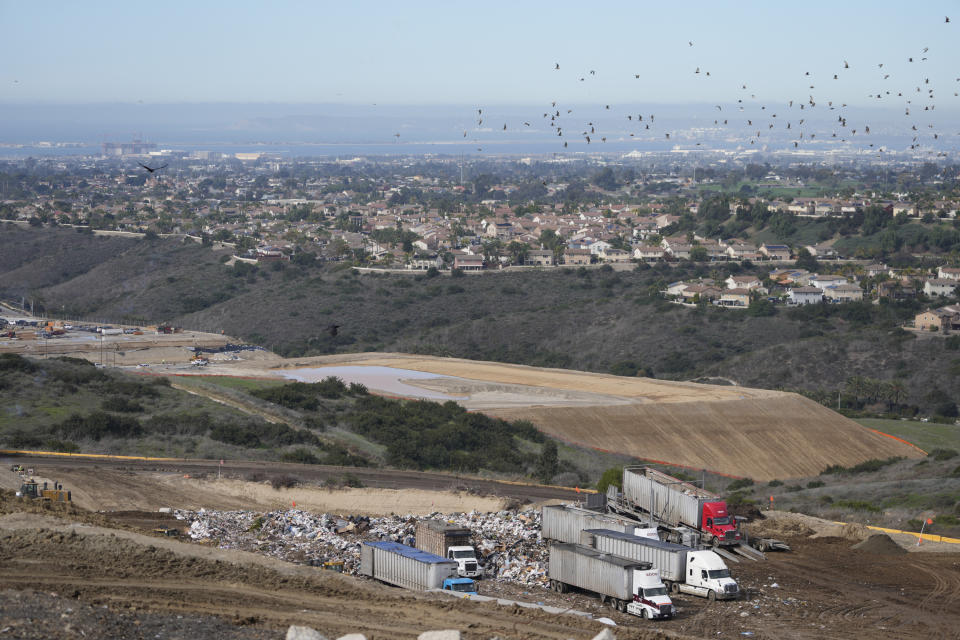 Trucks dump trash at the Otay Landfill in Chula Vista, Calif., on Friday, Jan. 26, 2024. Two years after California launched an effort to keep organic waste out of landfills, the state is so far behind on getting food recycling programs up and running that it's widely accepted next year's ambitious waste-reduction targets won't be met. (AP Photo/Damian Dovarganes)