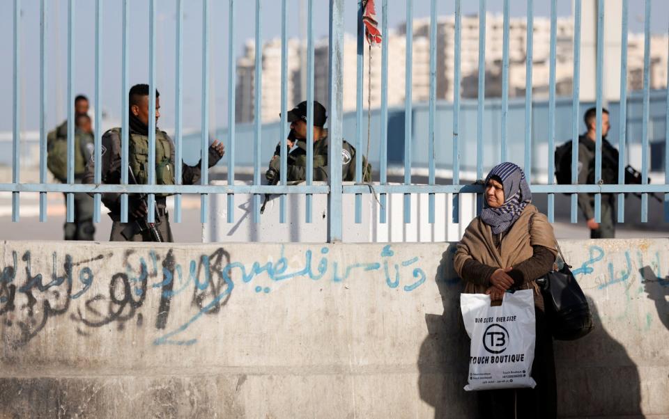 A Palestinian woman is denied permission to attend the last Friday prayers of Ramadan at Jerusalem's Al-Aqsa mosque