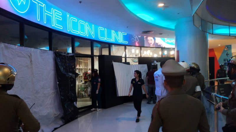 Emergency services are seen in front of a cosmetic clinic after a shooting at a shopping mall in Bangkok
