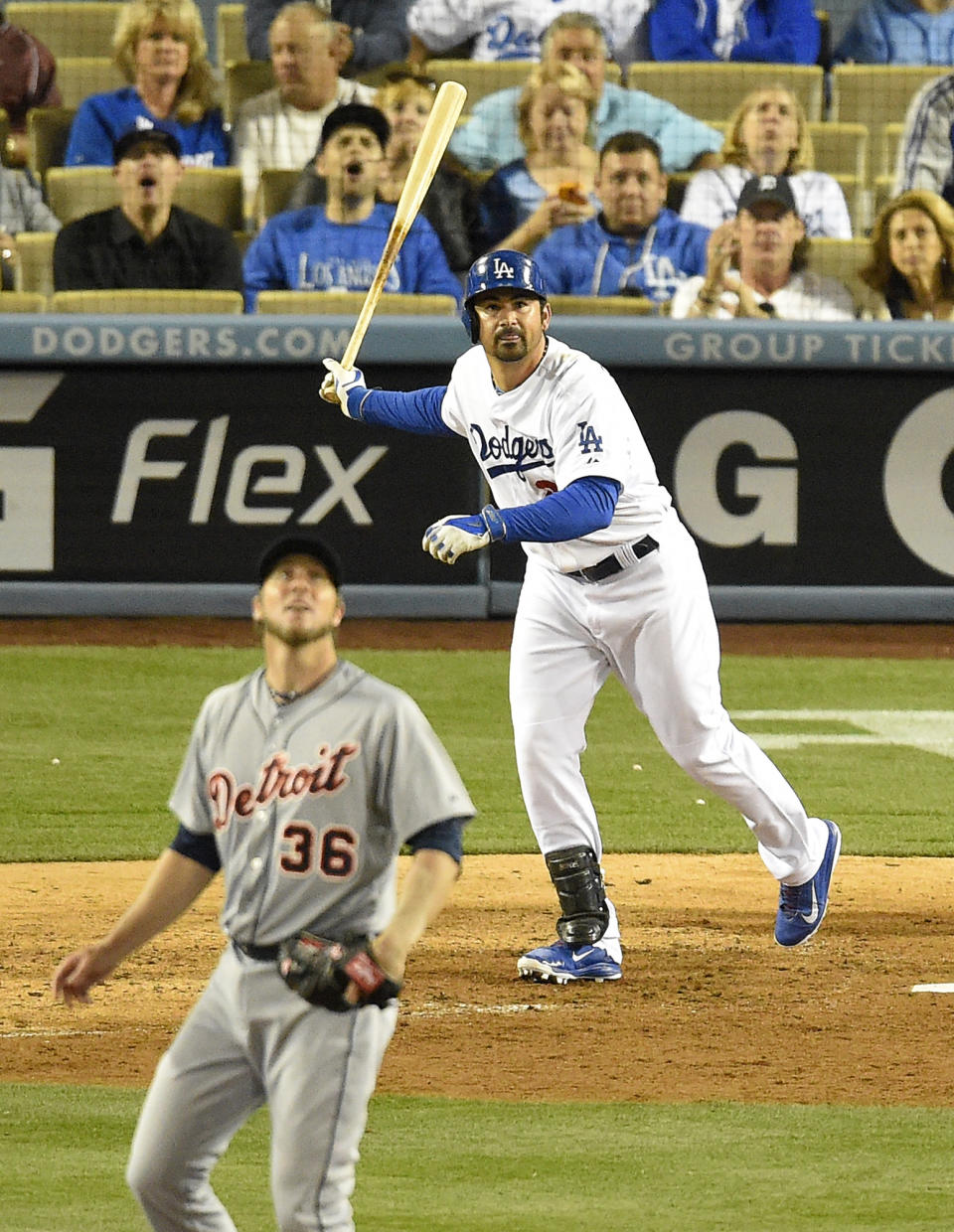 Los Angeles Dodgers' Adrian Gonzalez, right, hits a solo home run as Detroit Tigers relief pitcher Joe Nathan looks on during the ninth inning of a baseball game, Wednesday, April 9, 2014, in Los Angeles. (AP Photo/Mark J. Terrill)