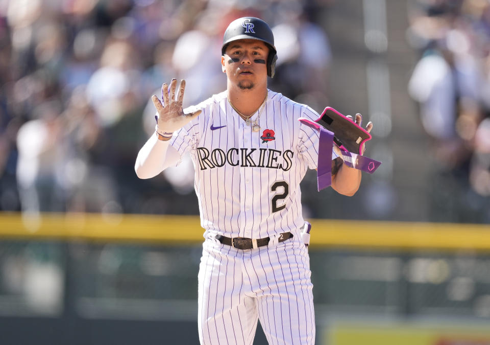 Colorado Rockies pinch-hitter Yonathan Daza gestures to the dugout after hitting a double that drove in three runs off Miami Marlins relief pitcher Cole Sulser in the seventh inning of a baseball game Monday, May 30, 2022, in Denver. (AP Photo/David Zalubowski)
